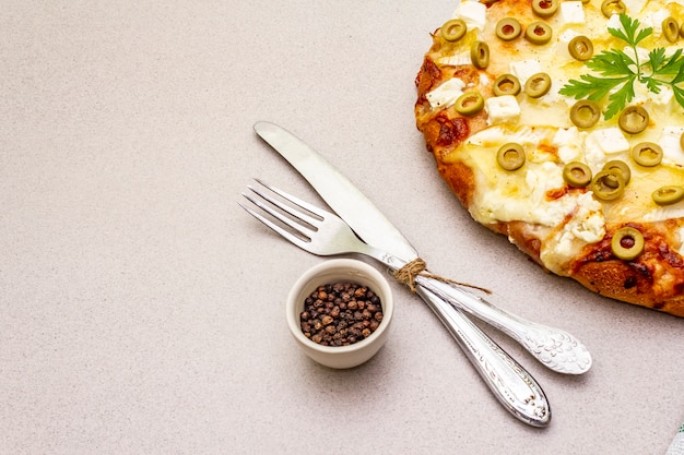 Italian focaccia with three types of cheese, green olives, black pepper and parsley