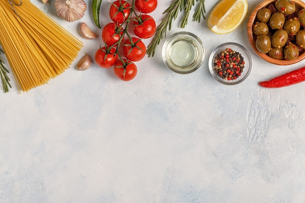 Italian food background with pasta, spices and vegetables 