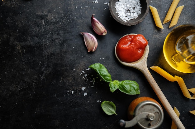 Italian food background with spaghetti spices and sauce View above