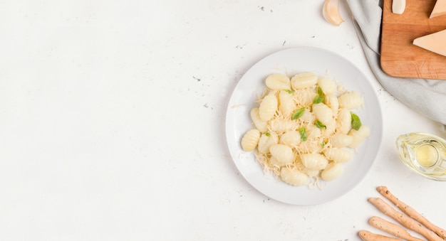 Italian food. Gnocchi with cheese on a white plate. Copy space.