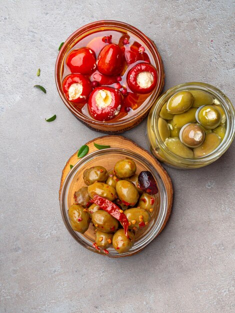 Italian food ingredients background with olives oil red stuffes with cheese bell peppers