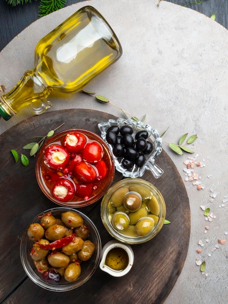 Italian food ingredients Black and green olives in glass bowls and olive oil stuffed with cheese