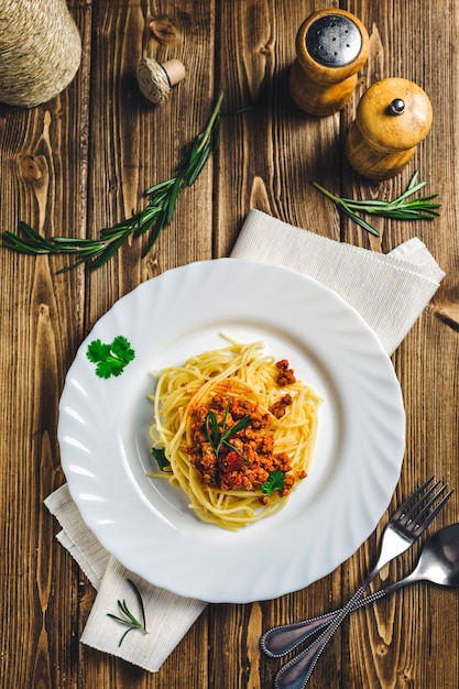 Italian food pasta Bolognese beef on a wood 