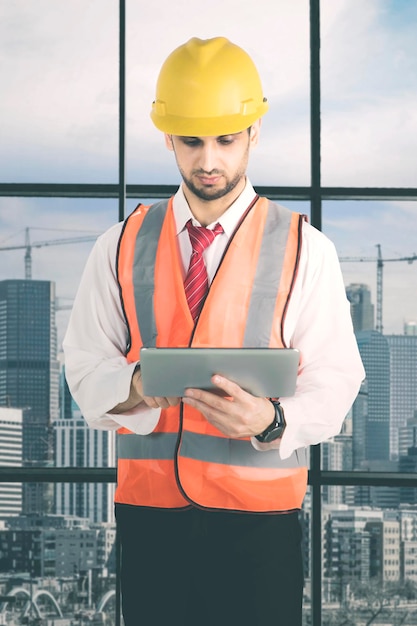 Italian foreman using a tablet in the office