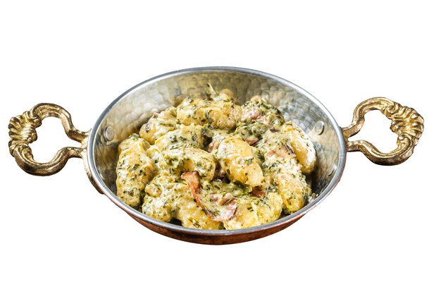 Italian Gnocchi potato pasta with spinach and parmesan in skillet Isolated on white background Top view