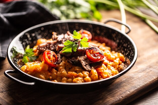 Premium Photo | Italian gnocchi sous with fresh sauce, topped served with beef in tomato and vide