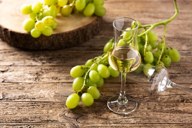 Italian golden grappa drink on wooden table