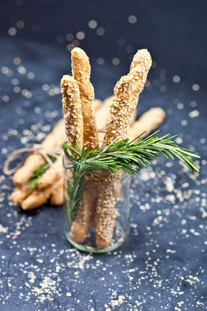 Foto grissini italiani o pane salato con erbe di sesamo e rosmarino