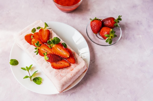 Italian homemade dessert Semifreddo with strawberry sauce cold dessert like an icecream