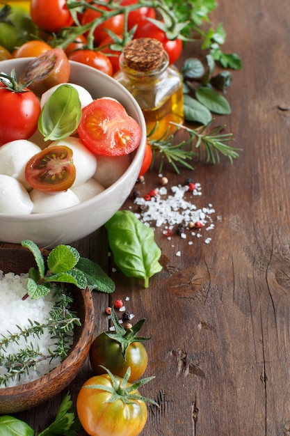 Italian ingredientsfor caprese salad on wooden table  close up