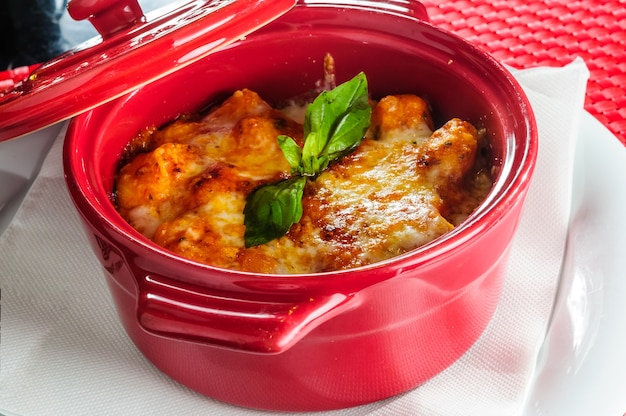 Italian lasagna plate served with fresh basil leaf