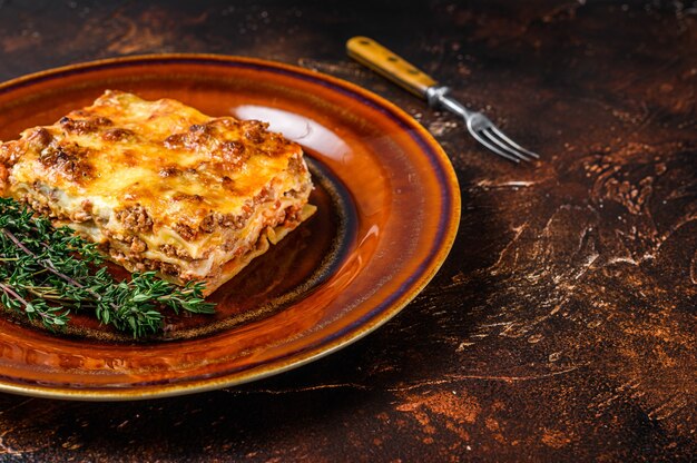 Italian Lasagne with tomato bolognese sauce and mince beef meat on a rustic plate