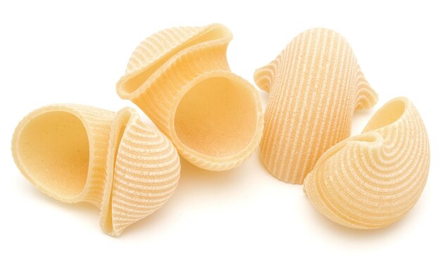 Italian lumaconi isolated on white background Lumache snailshell shaped pasta