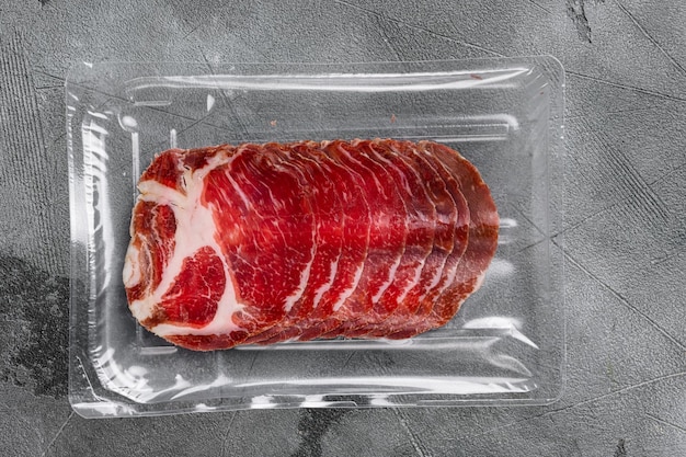 Italian meat cold cuts pack set, on gray stone table\
background, top view flat lay