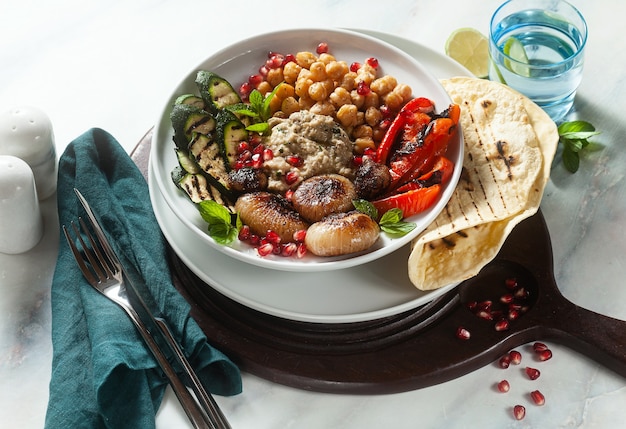 Italian Mediterranean Buddha bowl with Baba ghanoush caramelized onions