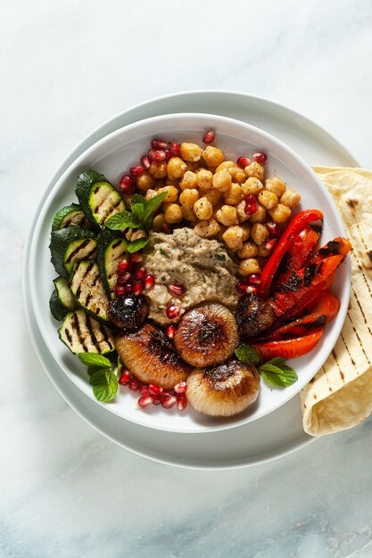 Italian Mediterranean Buddha bowl with Baba ghanoush caramelized onions