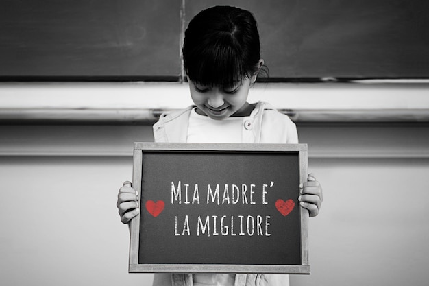 Photo italian mothers day message against schoolchild with blackboard