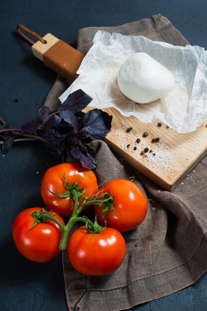 Italian mozzarella cheese, tomatoes, Basil. Ingredients for Caprese salad.