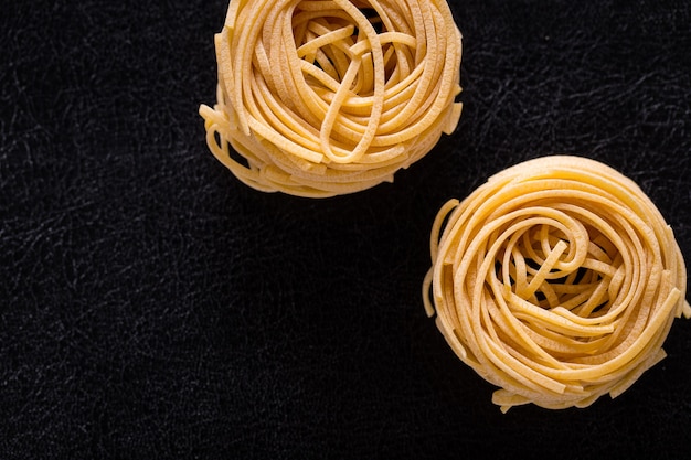 Italian pasta on a black isolated background close-up.