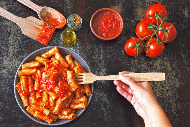 Italian pasta in a bowl with fresh tomato sauce. Vegan bowl with pasta in tomato sauce.