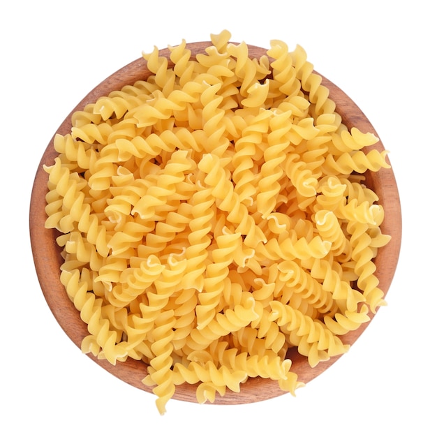 Italian pasta fusilli in a wooden bowl isolated 