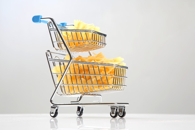 Italian pasta in a grocery basket from the market on a white background. flour products and food in cooking