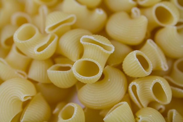 Italian pasta made from flour sprinkled on the table in a large quantities