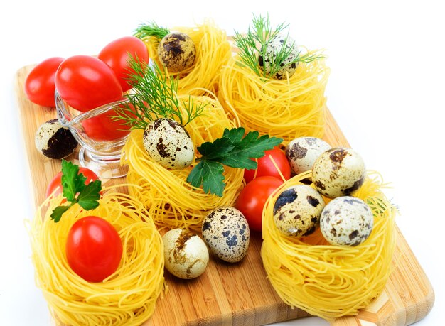 Italian pasta nests with cherry tomatoes and quail eggs.