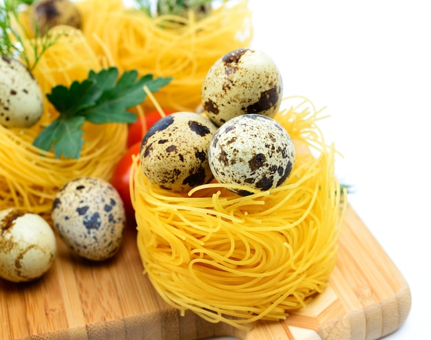 Italian pasta nests with cherry tomatoes and quail eggs.