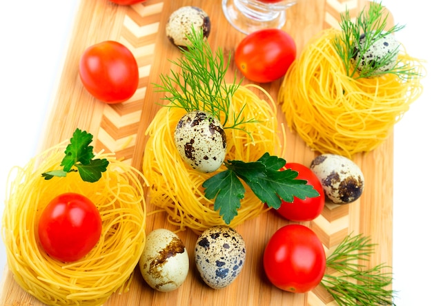 Italian pasta nests with cherry tomatoes and quail eggs.