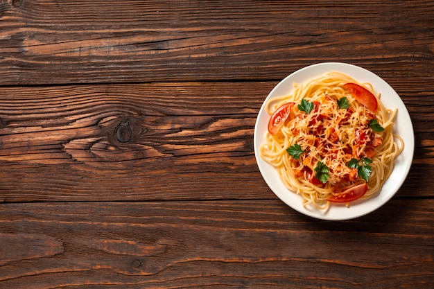 Italian pasta on rustic wooden background. Flat lay. Top view.