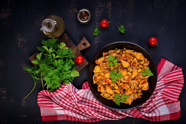 Italian pasta shells with mushrooms, zucchini and tomato sauce