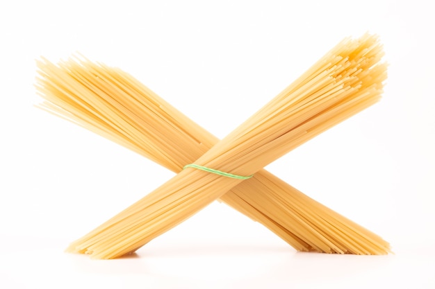 Italian pasta spaghetti on a white background. flour products and food in cooking