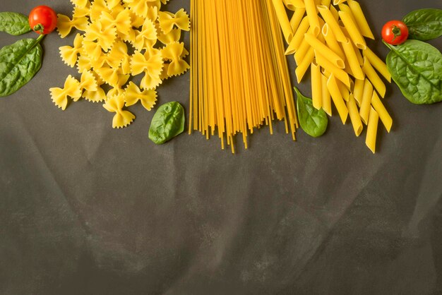 Italian pasta with cherry tomatoes spinach and cheese flat lay