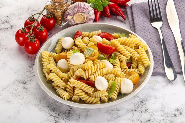 Italian pasta with mozzarella and tomato