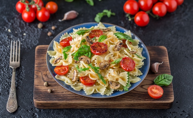 Italian pasta with sauce, cherry tomatoes, basil and parmesan cheese. Delicious pasta plate