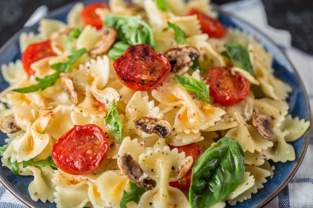 Italian pasta with sauce, cherry tomatoes, basil and parmesan cheese