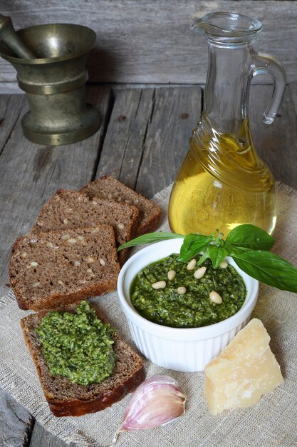 Italian pesto sauce and rye toast on a wooden table