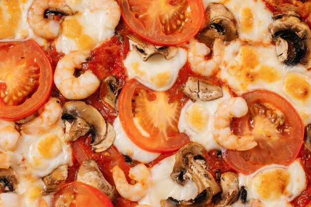 Italian pizza filling closeup with mushrooms tomatoes and cheese