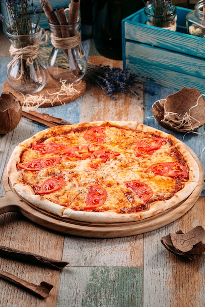 Italian pizza margarita with tomatoes and cheese