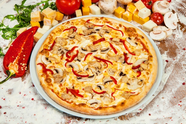 Italian pizza with different sorts of cheese vegetables and meat