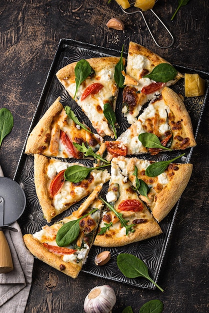 Italian pizza with feta cheese tomato and basil