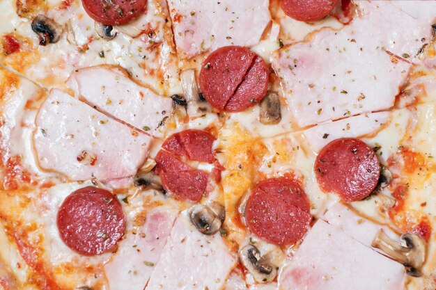 Italian pizza with ham salami and mushrooms