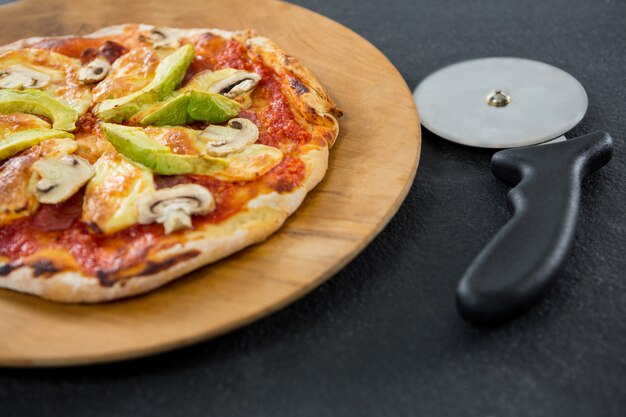 Italian pizza with pizza cutter on a tray