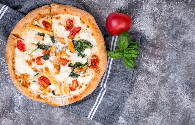 Italian pizza with tomato, mozzarella and chicken