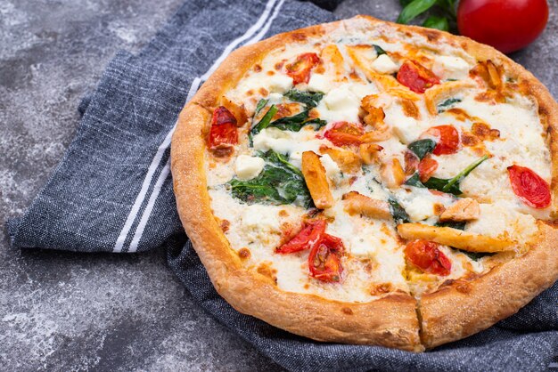 Italian pizza with tomato, mozzarella and chicken