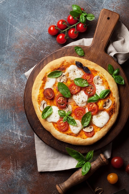 Italian pizza with tomatoes mozzarella and basil