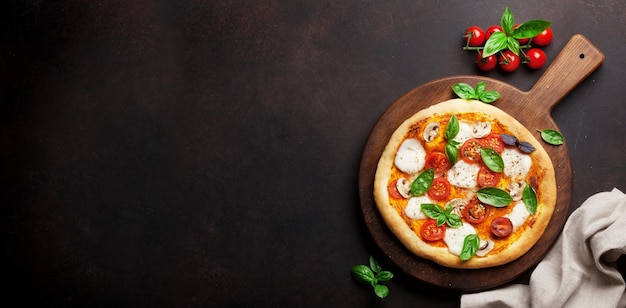 Italian pizza with tomatoes mozzarella and basil