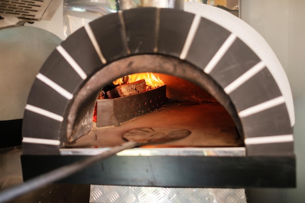 Italian pizza wood stove Italian pizza is cooked in a woodfired oven Street food cooking concept