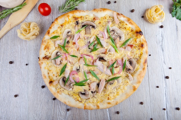 italian pizza on a wooden background with decoration around